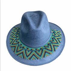 Suede Cowgirl Hat With Chaquira Beaded Hat Band. The Hat Band Is Removable, Ties To Adjust. It Can Also Be Use As A Necklace. Sweatband On Hat Makes It More Comfortable To Wear. Includes Hat And Hat Band. Size-Medium Handmade In Chiapas Mexico. Blue Beaded Hat Bands For Festival, Bohemian Blue Felt Hat With Short Brim, Blue Bohemian Felt Hat With Short Brim, Blue Wide Brim Bohemian Felt Hat, Bohemian Blue Wide Brim Felt Hat, Blue Bohemian Wide Brim Felt Hat, Bohemian Blue Short Brim Felt Hat, Blue Wide Brim Hat For Festival, Blue Fedora Felt Hat For Festivals