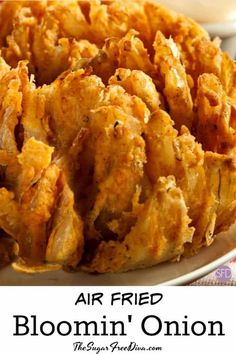 a plate full of fried food with the words air fried bloomin'onion on it