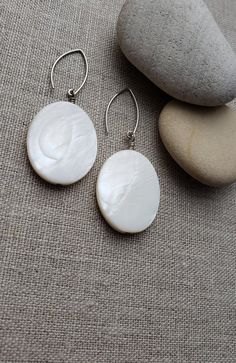 SALE SALE SALE White Shell Earrings Beads Used to make these beauties: White Shell Beads, Silver Plated Accents. Measure: approximately 2.25 inches, Width 25mm Please convo me with any questions, I'm very helpful! All of Made On Urth Jewelry is handmade and high quality! All orders will receive a free pair of earrings! MAdE WiTH LOvE?  MaDE WiTH LOvE! Oval Pearl Drop Hoop Earrings Gift, Silver Oval Pearl Earrings, White Oval Hoop Earrings For Gift, Oval White Pearl Earrings, Handmade Oval Hoop Earrings, Oval Pearl Drop Jewelry, Handmade Oval Earrings For Gift, Gift Oval Pearl Drop Earrings, White Oval Sterling Silver Hoop Earrings