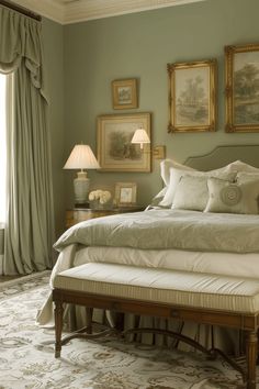 a bedroom with green walls and pictures on the wall