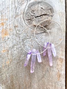 Raw purple quartz crystal points in gold or silver hoop earrings with French hooks. Perfect little boho look. Light weight and easy to wear. Add these to your boho outfits and make a 💜Healing clear quartz Crystal property has been know for centuries to restore balance in the body. -Options- 30mm as shown 21 gauge hoops Total drop Length: 2.3 inches 14k Gold filled hoops Sterling silver hoops Gold plated hoops Silver plated hoops All comes with hooks Simple, Dainty, Delicate, yet so Elegant and Spiritual Hoop Earrings With Ear Wire, Purple Amethyst Hoop Jewelry, Everyday Purple Jewelry With Ear Wire, Bohemian Sterling Silver Hand-wrapped Earrings, Bohemian Sterling Silver Hand Wrapped Earrings, Nickel-free Purple Hoop Earrings, Adjustable Nickel-free Purple Hoop Earrings, Purple Hoop Jewelry, Everyday Amethyst Dangle Jewelry