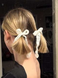 a woman with her hair in a ponytail wearing two crochet bowknots