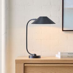 a table lamp sitting on top of a wooden dresser