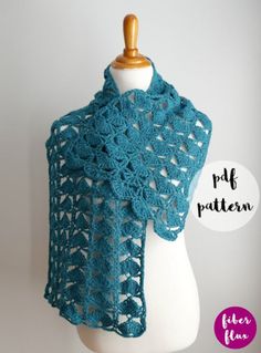 a blue crocheted shawl on a mannequin