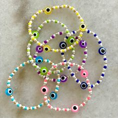 8mm evil eye beads with 3mm seed beads. Primary color denotes evil eye color with matching seed bead, secondary color denotes silver or gold accent beads. Please note size in personalization section. All bracelets made with white beads unless otherwise specified in personalization section. All bracelets are completely customizable, please add customization in personalization section &  please message me with questions! White Spiritual Friendship Bracelets With Colorful Beads, Adjustable Evil Eye Beaded Bracelets For Everyday, Silver Beaded Bracelets With Evil Eye, White Evil Eye Bracelet With Round Beads, White Beaded Round Evil Eye Bracelet, White Round Beaded Evil Eye Bracelet, Multicolor Tiny Beads Evil Eye Bracelet, White Evil Eye Bracelet With Colorful Round Beads, White Evil Eye Bracelet With Tiny Round Beads