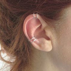 a close up of a person with ear piercings