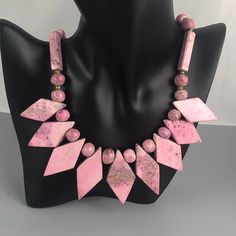 "This is a lovely vintage necklace featuring diamond-, sphere-, and cuboid-shaped beads made of a beautiful pink gemstone. On the Presidium gem tester, it reads in the tourmaline, garnet, iolite range (see listing video). It is most likely rhodonite. The necklace has a barrel clasp. Weight: 112 grams (3.95oz.) Length: 18\" (45.72 cm) Very good condition with no visible imperfections. All jewelry is sold in used, preowned condition. Vintage and antique items are expected to have some wear, imperf Pink Gemstone Bead Necklaces, Vintage Faceted Beaded Necklaces, Pink Round Gemstone Beads Necklace, Bohemian Pink Necklace With Polished Beads, Vintage Faceted Crystal Necklaces For Gifts, Pink Polished Beads Spiritual Jewelry, Vintage Faceted Round Bead Necklaces, Vintage Polished Beads Necklaces, Vintage Faceted Beaded Necklaces For Gifts