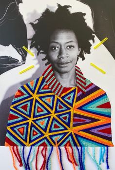 a woman with dreadlocks on her head and an art piece in the background