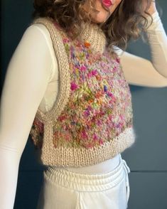 a mannequin wearing a knitted sweater and white pants