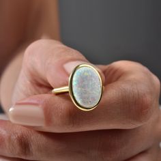 Opal Ring, Vintage Opal Ring, Minimalist Ring, Mother's Day Gift, October Birthstone Ring, Stacking Ring, Gift For Her Elevate any look with our Vintage Opal Ring. This minimalist piece exudes timeless charm, making it a perfect gift for Mother's Day or October birthdays. Crafted with care, its iridescent opal centerpiece adds a touch of elegance to any outfit. Stack it or wear it solo for understated luxury. A beautiful minimalist piece to have in ones collection 🎀 Free Returns and Money-back White Opal Stackable Rings As Gift, White Opal Stackable Rings Gift, Oval Opal Stackable Rings As Gift, Stackable Oval Opal Rings, 14k Gold Opal Open Ring Gift, Yellow Gold Opal Ring Oval Cabochon For Gift, 14k Gold Open Opal Ring Gift, Gemstone Signet Ring With Round Band As A Gift, Yellow Gold Opal Ring Gift