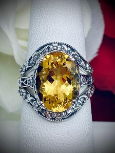 Natural Yellow Citrine Ring and Curved Band Set Option Edward Design#70 Made To Order This filigree ring is an Edwardian antique reproduction in sterling silver set with a 4+ carat natural honey-yellow citrine gemstone solitaire. This faceted cut oval gem is 14mm x 10mm. This ring sits 7mm off the finger. The inside of the band is marked 925 for sterling silver. This ring now has a matching floral accompanying curved band. This band was specially designed to fit this ring perfect. You can elect Elegant Amber Rings With Gemstone Accents, Classic Citrine Gemstone Jewelry, Classic White Gold Citrine Jewelry, Classic Citrine Jewelry With Gemstone Accents, Classic Rings With Gemstone Accents For Anniversary, Exquisite Hallmarked Gemstones For Anniversary, Classic Anniversary Rings With Gemstone Accents, Classic Hallmarked Citrine Jewelry, Citrine Gemstone Wedding Ring