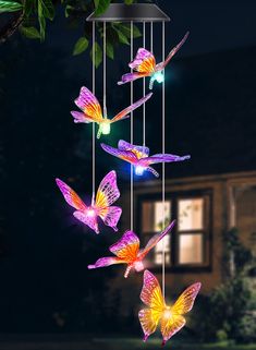 a wind chime with butterflies hanging from it's sides