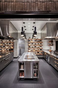 a large kitchen with stainless steel appliances and counters