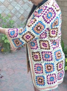 Handmade Crochet  Knit Colorful Winter  GRANNYs  sweater cardigan Measurements of this boho jacket cardigan gown : Size: Free size, i will send any size that you want Made of highest quality acrowool acrylic blend yarn Very stylish and fashionable  elegant and keeps you very warm Wash Instructions: Machine washable at low temperatures. -machine wash gentle (40 C/104 F) -tumble dry on low heat Unique designers print, handcrafted with love Great gift for yourself or for your loved ones Bohemian Long Sleeve Multicolor Cardigan, Bohemian Multicolor Long Sleeve Cardigan, Multicolor Long Sleeve Bohemian Cardigan, Granny Square Long Sleeve Cardigan For Festivals, Granny Square Long Sleeve Festival Cardigan, Long Sleeve Granny Square Cardigan For Festival, Festival Long Sleeve Granny Square Cardigan, Bohemian Multicolor Cardigan For Festivals, Bohemian Long Multicolor Cardigan