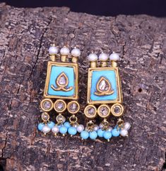 This Earrings is crafted using traditional techniques in 22k Yellow Gold with turquoise pearls and Polki Diamonds. The Turquoise are all natural and have a rough organic look, thus enhancing the rawness and beauty of the piece. Turquoise also known as Firoza has remarkable healing properties and ensure overall physical fitness. It enhances immunity and eliminates pollution inflicted diseases. The Birthstone for December, Turquoise is said to bring good luck, peace and protection. Turquoise is also the 11th wedding anniversary gemstone. Gross Weight: 12.930 gms Dimensions: Length: 36mm Width: 16mm Perfect for any look or occasion!  Packaging and Shipping Your item is packed very carefully to avoid any in-transit damage. We first pack it in a zip pouch and then put it in a Bubble Pouch. Your Turquoise Temple Jewelry Earrings For Festivals, Elegant Turquoise Kundan Earrings, Turquoise Meenakari Temple Jewelry Earrings, Turquoise Earrings For Festive Occasions, Festive Turquoise Temple Jewelry Earrings, Traditional Turquoise Earrings For Wedding, Festive Turquoise Earrings As Gift, Festive Turquoise Earrings For Gift, Traditional Turquoise Danglers For Gift