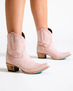 Heirloom quality pink ankle boots with a core western influence. The classic snip toe profile is embroidered to perfection with a twist on traditional flame stitch in bootie form. Blush Pink Cowgirl Boots Heel Height: 1.75" Shaft Height: 8" Ankle Circumference: 12" Toe Shape: Snip Distressed Stonewash Finish Signature Turquoise Soles Pink Western Ankle Boots, Western Style Pink Mid-calf Boots For Winter, Pink Western Snip Toe Boots, Ponk Cowgirl Boots, Western Style Fitted Pink Mid-calf Boots, Pink Ankle Boots, Wedding Cowboy Boots, Pink Cowboy Boots, Pink Cowgirl Boots