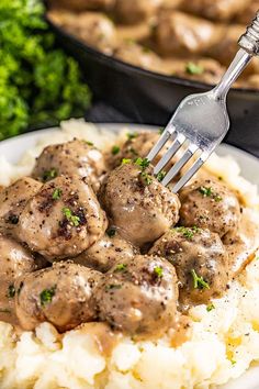 meatballs and gravy on top of mashed potatoes