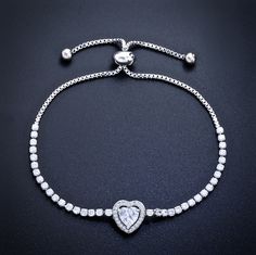 Delicate and elegant, this adjustable heart bracelet will add a touch of sophistication to any wedding gown or formal ensemble. Adorned with heart-shaped cubic zirconia that captures the light from every angle with a perfectly translucent appeal, the bracelet is rhodium / rose gold / yellow gold plated for a flawless finish which perfectly enhances the intricate detailing and conveys a modern take on old elegance. The bracelet measures 0.4" (approx. 1cm) at the widest point, and the adjustable c Elegant Heart Shaped Cubic Zirconia Jewelry, Elegant Heart-shaped Cubic Zirconia Jewelry, Adjustable Heart Bracelet For Formal Occasions, Wedding Jewelry With Heart Charm In Cubic Zirconia, Cubic Zirconia Heart Charm Jewelry For Wedding, Wedding Jewelry With Cubic Zirconia Heart Charm, Elegant Heart Charm Jewelry In Cubic Zirconia, Elegant Cubic Zirconia Jewelry With Heart Charm, Formal Cubic Zirconia Jewelry With Heart Charm