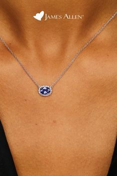 Celebrate a classic look with this necklace featuring an east-west set tanzanite oval surrounded by a halo of diamonds and a signature clasp for a perfect adjustable fit | James Allen Necklace Style: 8340727W14 | #diamondpendant #diamond #diamonds #diamondjewelry #diamondnecklace #diamondring #jewelry #diamondearrings #jewellery #pendant #diamondjewellery #finejewelry #jewellerydesign #whitegold #fashion #gemstone #jamesallen Diamond Halo Necklace, Oval Tanzanite Halo Jewelry, Oval Tanzanite Jewelry With Gemstone Accents, Bold Statement Jewelry, Tanzanite Pendant, Jewellery Pendant, Tanzanite Necklace, Diamond Necklace Designs, Halo Necklace