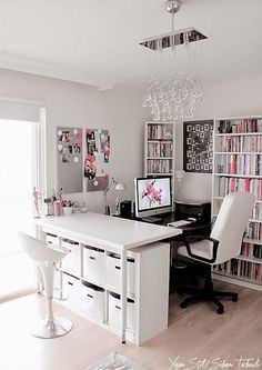 a home office with lots of bookshelves and white furniture