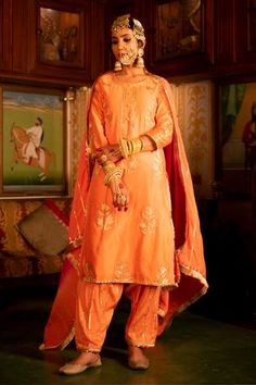 Orange chanderi silk kurta in pittan work. Paired with cotton silk gota dhari salwar and muslin silk ombre dupatta.
Component: 3
Pattern: Hand embroidered
Type Of Work: Gota patti, pittan work
Neckline: Round
Sleeve Type: Three quarter
Fabric: Chanderi silk, Cotton silk, Muslin silk
Color: Orange
Other Details: 
Gota patti trims kurta
Fringe dupatta
Note: Hair accessory and jewellery worn by the model are not for sale
Occasion: Reception, Wedding - Aza Fashions Salwar Pants, Silk Kurta, Designer Party Wear Dresses, Red Ombre, Indian Fashion Designers, Silk Dupatta, Pernia Pop Up Shop, Fashion App, Indian Ethnic Wear