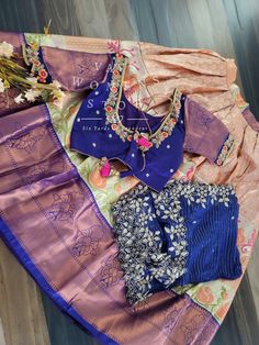 This Traditional Half Saree Set is a must-have for any woman looking to add a touch of elegance and tradition to her wardrobe. Made from premium quality Kanchi material, this saree set is not only beautiful but also durable and comfortable to wear. The set includes a blouse that is stitched and comes in a size 34, with inner margins that can be expanded up to size 40. For those who need a size 32, alterations can be done upon request. The lehenga is also expandable and has inner margins to incre Designer Wear Tissue Silk Sets With Cutdana, Designer Tissue Silk Sets With Cutdana, Designer Wear Sets With Cutdana In Tissue Silk, Blue Tissue Silk Saree Set, Traditional Blue Tissue Silk Sets, Designer Tissue Silk Set With Dori Work, Traditional Drape Sets In Tissue Silk With Dori Work, Traditional Drape Sets With Zari Work In Tissue Silk, Dola Silk Sets With Pallu