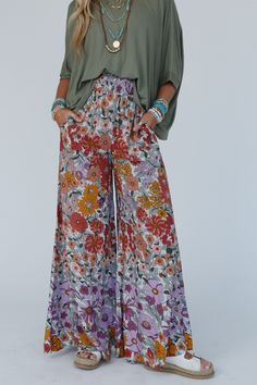 Elevate your boho wardrobe with the Blissful Burst Floral Pants - with their trendy wide legs and comfortable fit, you'll feel stylish and confident in any setting! Boho fabric that drapes beautifully and adds a touch of texture Bold floral print for an eye-catching look Palazzo silhouette with flared wide legs for a relaxed and breezy feel Thick smocked elastic waistband for good fit Convenient side seam pockets Pair with: Sophie Crochet Lace Bralette, On The Go V Neck Ribbed Essential Tee and Blue Floral Pants Outfit, Bohemian Floral Print Beach Bottoms, Bohemian Floral Beach Bottoms, Summer Floral Print Wide Leg Maxi Skirt, Bohemian Maxi Bottoms With Floral Print, Bohemian Maxi Length Bottoms With Floral Print, Bohemian Maxi Length Floral Print Bottoms, Floral Print Maxi Bottoms For Vacation, Flowy Boho Print Bottoms For Spring