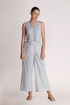 This white printed motif pant is a love story that blossoms sophistication with a tinge of charm. The relaxed fit of the pants gives a fresh look to the small motif prints on display. Mindfully crafted from cotton, it's like a superhero for the summer, ready to rescue you from sweat and stickiness. Rock this look with the Aster Printed Motif top & classy shoes or stilettos, and let the flower power spread its magic wherever you go! Material: CottonStyle/Print: Small Motif Handblock PrintPant Len Blue Lily, Classy Shoes, A Love Story, Fabric Covered Button, Floral Scarf, Fresh Look, Summer Ready, Printed Pants, Vest Top