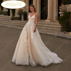 a woman standing in front of a building wearing a wedding dress