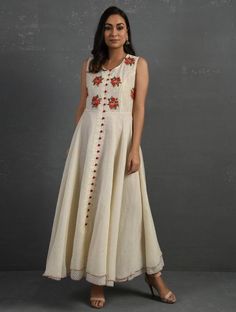 A double-layered umbrella cut front open Chanderi kurta with all-over floral buttis in yoke made using beads, sequins and silk French knots. Beadwork runs along the neckline and armhole. Contrast buttons and scalloped edges embroidered double layered flared hemline. The kurta comes with a delicate chanderi dupatta with all over sequence work and a wide woven zari border at the hem. Kurta measurements (in Inches): Size S: Bust - 38", Waist - 35", Length: 52" Size M: Bust - 40", Waist - 37", Lengt Sleeveless Kurta With Zari Work For Reception, Off White Raw Silk Anarkali Dress, Off White Anarkali Dress In Raw Silk, Designer Sleeveless Raw Silk Kurta, Traditional Sleeveless Embellished Anarkali Set, Designer Sleeveless Kurta With Mirror Work, Festive Cotton Silk Dress With Floral Embroidery, Elegant Sleeveless Designer Kurta, Designer Cotton Silk Dress With Floral Embroidery