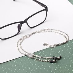 Modern glasses chain - White jade gemstone and grey bead eyewear chain White jade gemstones with grey faceted glass beads and Tibetan silver beads feature in a silver tone oval link chain. Perfect for everyday wear and keeping your glasses or sunglasses handy. Finished with spectacle ends to hold your glasses. Approximately 26 inches long. Handmade in the UK, in stock and ready to ship. More glasses chains available in my store here - https://www.etsy.com/shop/inspira?section_id=20362036 California Lilac, Eyeglasses Chain, Eyewear Chain, Glasses Chains, Sunglasses Strap, Jade Gemstone, Grey Beads, Eyeglass Chain, White Jade