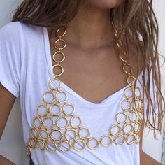 90s inspired racerback Chain Mail bra, sure to turn heads. Wear it over a tight mesh bodysuit and bellbottoms or dressed down with a basic tee and boyfriend jeans. This unique piece fits over the head and is adjustable at the bust. Available in gold or silver. Materials: Stainless Steel/ 18K Gold Plating Size: Based off bust size *Hypoallergenic, Lead and Nickel Free, Tarnish Resistant Care: Our jewelry is designed to be water-resistant, so you don't have to worry about taking it off when you're Bra Jewelry, Music Festival Accessories, Geometric Fashion, We Are Festival, Metalwork Jewelry, Mesh Bodysuit, Chain Mail, 90s Inspired, Body Chain Jewelry