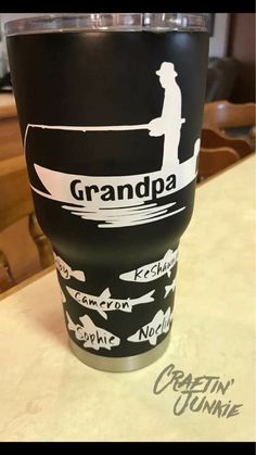 a black and white coffee cup sitting on top of a counter