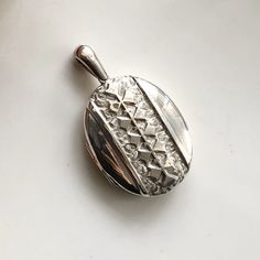 A large antique silver locket pendant. A beautifully decorated piece perfect for displaying an old photograph or two. CONDITION: Good condition, wear consistent with age and use. Good click but pops open after time. Please see photos for more detail. Glass still inside.  LOCKET SIZE: 43mm x 35mm LOCKET LENGTH INC. LOOP: 60mm LOCKET WEIGHT: 14.8 WINDOW SIZE (INSIDE): 40mm x 30mm (8-11-10) Antique Silver Engraved Locket Necklace For Memorial, Engraved Antique Silver Locket Necklace For Memorial, Antique Silver Sterling Silver Vintage Locket Necklace, Collectible Hallmarked Silver Locket Necklace, Silver Hallmarked Locket Necklace Collectible, Victorian Silver Locket Necklace, Ornate Engraved Antique Silver Locket Necklace, Vintage Silver Medallion Locket Necklace, Silver Vintage Medallion Locket Necklace