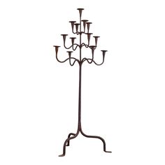 a metal candelabra with twelve candles on it's stand, isolated against a white background