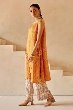 Orange shift dress kurta with sunflower patterns in crushed bandhani work and side button down panels. - Aza Fashions Sleeveless Chanderi Dress With Chikankari Embroidery, Sleeveless Chikankari Chanderi Dress, Summer Chanderi Dress With Cutdana Detail, Summer Cutdana Chanderi Dress, Sleeveless Gota Work Dress For Festivals, Sleeveless Gota Work Festival Dress, Bohemian Summer Dress With Gota Work, Fitted Bohemian Dress With Gota Work, Bohemian Sleeveless Dresses With Zari Work