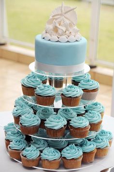 a wedding cake and cupcakes on a table with the title tropical cupcakes contact your travel professional to book your wedding destination today