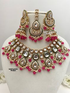 Premium quality Kundan Necklace comes with elegant Jhumki Earrings and Tikka/ trendy Indian bridal set/Premium Quality Polki and Kundan Jewelry/fuschia/Fucsia/hot pink/Rani/Magenta     All items are shipped from Brampton, Ontario, Canada. If you need your item by a certain day, please reach out to us for express delivery option before placing the order so that we can update the shipping for you. Standard shipping/delivery timeline Below are the delivery timeline estimates. We dispatch all orders Pink Heavy Bridal Necklace For Festive Occasion, Heavy Pink Bridal Necklace For Festive Occasions, Pink Heavy Temple Jewelry Bridal Necklace, Pink Hand Set Round Jewelry Sets, Heavy Pink Temple Jewelry Bridal Necklace, Heavy Pink Bridal Necklace For Festivals, Pink Kundan Necklace Gift, Festive Pink Kundan Necklace With Hand Set Details, Festive Pink Kundan Necklace With Hand Set Stones