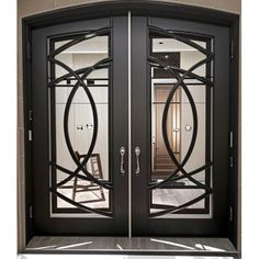 an elegant double door with glass panels and wrought iron work on the sides, leading to a foyer