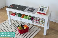 a white table with two bins and a calculator sitting on top of it