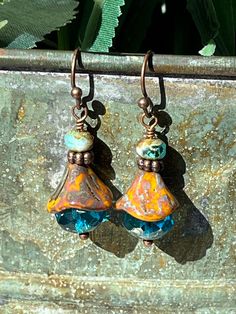 "Perfect dainty earrings to help us think of Spring flowers!!  These beautiful lightweight drop earrings are made with large blue fire-polished Czech glass topped with more light brown Czech glass in the shape of a flower with more copper and a small Czech bead.  A fun combination that you can wear with anything and sparkle!!  I love Czech glass - each bead is like a piece of artwork to me, so I have a lot of fun creating with them! **Each piece of Daisy Light Jewelry is delivered packaged in a brown kraft box with a double organza bow and charm.  If you have two or more boxes, I will note what is in each box for easy gift giving. **If you want Christmas color organza ribbon and Christmas charm, please make a note to me at checkout (silver, white, red, and/or green) **My \"professional pho Blue Teardrop Bohemian Flower Earrings, Blue Bohemian Teardrop Flower Earrings, Bohemian Blue Teardrop Flower Earrings, Bohemian Blue Flower Earrings With Dangling Beads, Unique Blue Flower Earrings With Ear Wire, Blue Teardrop Flower Earrings Nickel Free, Blue Teardrop Nickel Free Flower Earrings, Blue Teardrop Nickel-free Flower Earrings, Blue Beaded Drop Earrings With Bead Caps