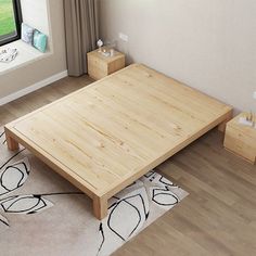 a bed room with a neatly made bed next to a window and a rug on the floor