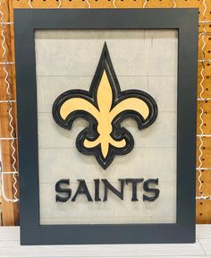 the new orleans saints logo is displayed on a wall