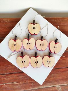 apples are arranged in the shape of an apple on a piece of paper with twine