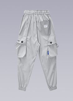 Exude confidence and sophistication in these cyberpunk-influenced baggy techwear pants. Introducing the Tech Cargos, an innovative and stylish fusion of performance and fashion that transcends the ordinary. These men's cargo pants are the ultimate expression of elegant multifunction, designed for young urban dwellers who seek to elevate their wardrobe and make a statement. Constructed with a sleek elastic waistband, our cuffed cargo pants boast a sophisticated metallic clamping buckle, ensuring a perfect fit tailored to your form. These baggy tech pants feature a generous cargo pocket with drawstrings at each knee, providing ample storage while enhancing your style. The elegant back pocket offers additional storage and style, while the high-performance tech clothing inspiration, blended wi Techwear Pants With Side Pockets, Functional Streetwear Cargo Pants With Multiple Pockets, Functional Cargo Pants With Multiple Pockets For Streetwear, Baggy Techwear Pants With Multiple Pockets, Baggy Techwear Pants With Cargo Pockets, Outdoor Techwear Parachute Pants With Side Pockets, Techwear Parachute Pants With Side Pockets For Outdoor, Techwear Parachute Pants For Streetwear, Functional Cargo Pants For Streetwear