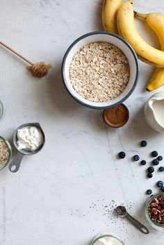 ingredients to make blueberry oatmeal are displayed on a white countertop