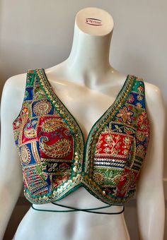 A green color embroidered blouse  Product details Fabric -Georgette Embroidery - Silk threads and sequins Bust size 34" Waist 28" Can be tailored to fit 36" For extra charges Sleeveless Embellished Choli For Festive Occasions, Bollywood Style Sleeveless Embellished Choli, Bollywood Sleeveless Embellished Choli, Festive Sleeveless Embellished Choli, Green Choli With Resham Embroidery For Summer, Sleeveless Choli With Intricate Embroidery For Festive, Sleeveless Choli With Intricate Embroidery For Festive Occasions, Sleeveless Party Blouse With Intricate Embroidery, Festive Sleeveless Choli With Intricate Embroidery