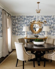 a dining room with blue and white wallpaper