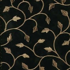 a black and gold fabric with leaves on it