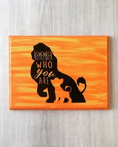 a wooden sign that says, remember who you are with an image of a lion on it